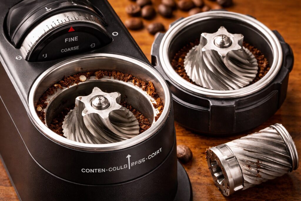 Burr grinder components showing conical burrs and grind adjustment